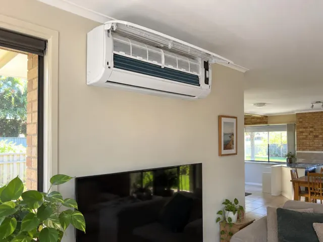 Open split-system indoor head with clean filters on a lounge room wall with tiled floor in Maudsland